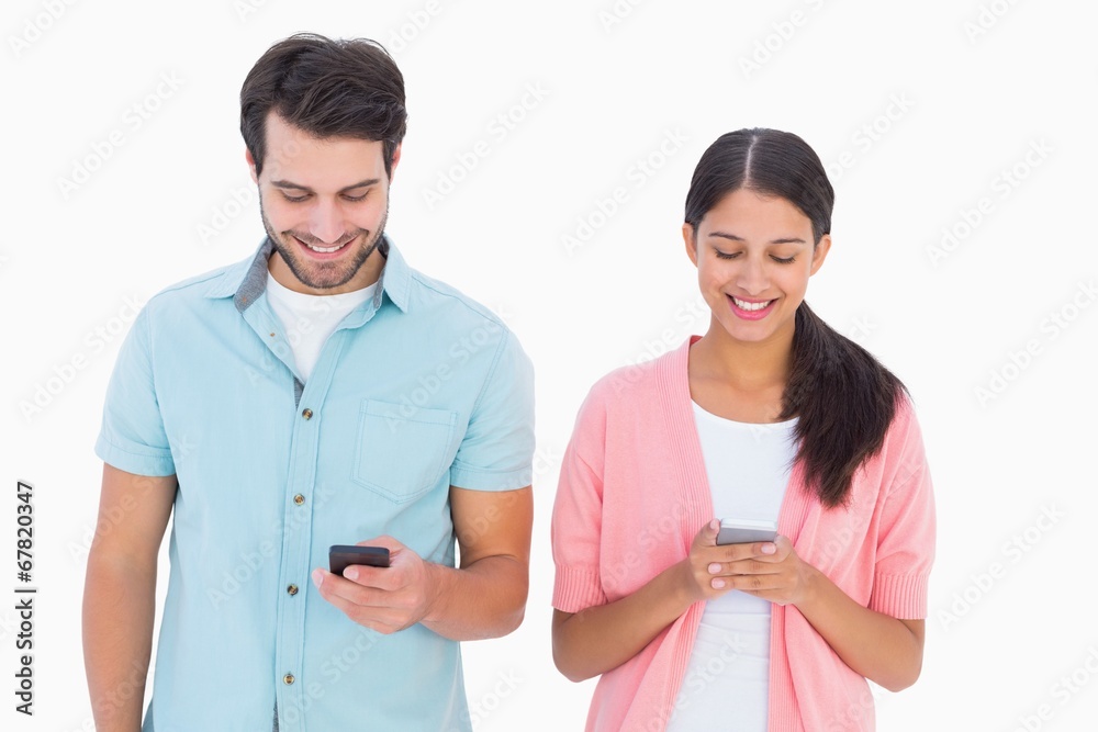 Happy couple sending text messages