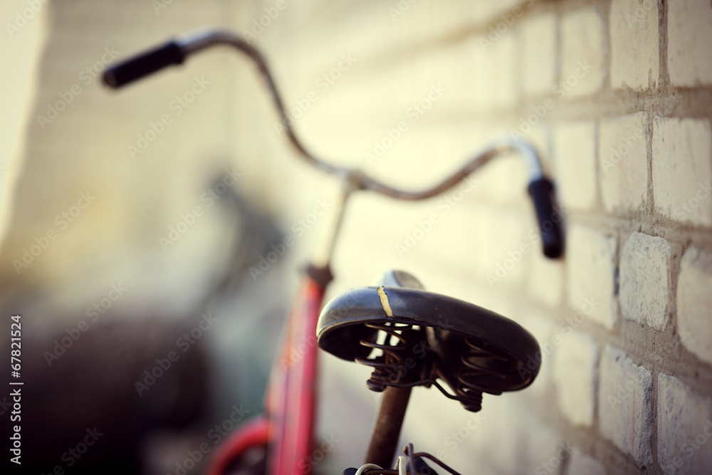 the old bicycle costs at a house wall the old bicycle costs at a house wall