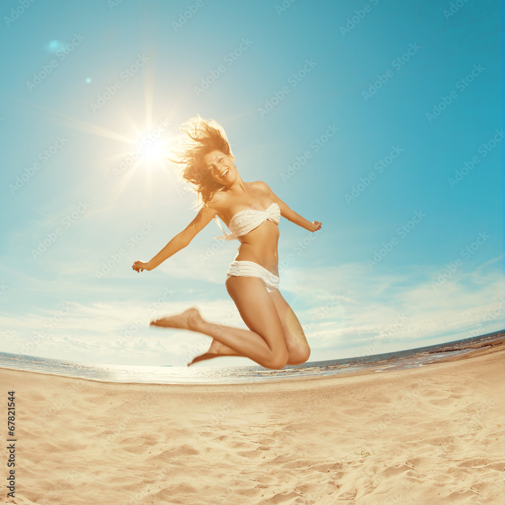 Naklejka premium Woman on the beach. Young girl on the sand by sea.