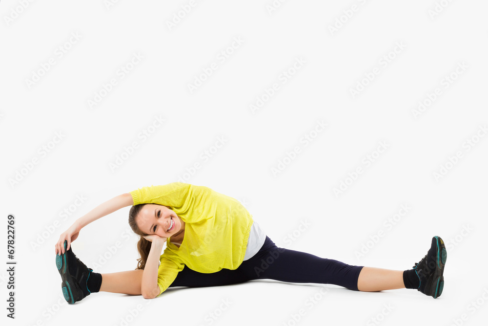 Split. Young woman doing stretching exercise. Isolated on white Split. Young woman doing stretching exercise. Isolated on white