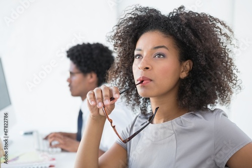 Young editor thinking at her desk photo