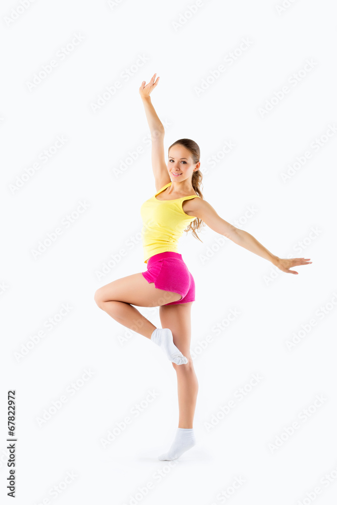 Young beautiful woman posing in a gym outfit. Young beautiful woman posing in a gym outfit.