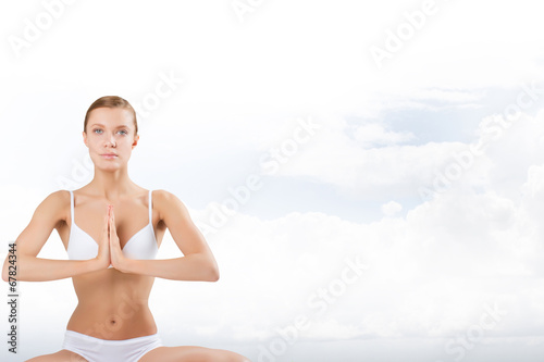 Beautiful positive girl in white underwear sitting
