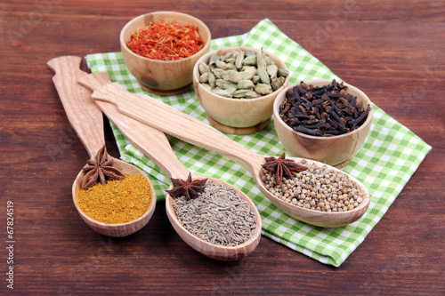 Various spices and herbs on wooden background