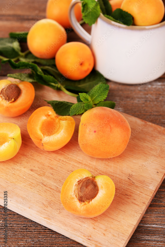 Ripe apricots with green mint leaves Ripe apricots with green mint leaves