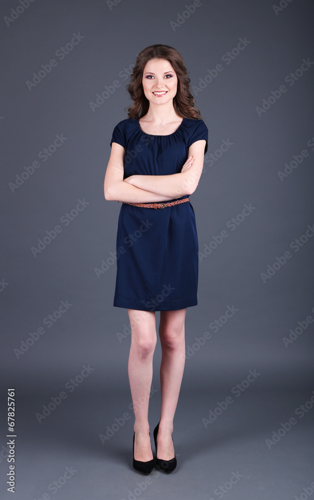 Beautiful young girl in dress on grey background Beautiful young girl in dress on grey background