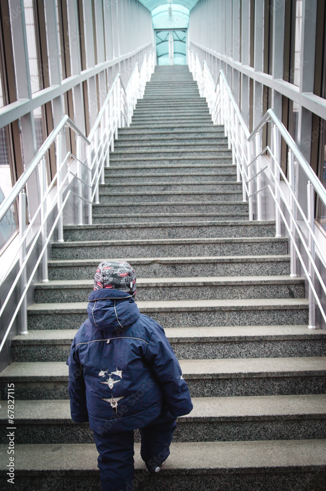 boy makes the first steps up stairs