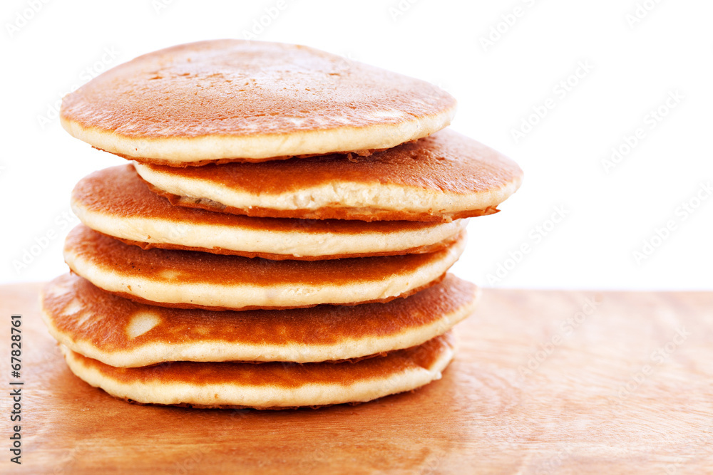Stack of pancakes on wooden board with white background Stack of pancakes on wooden board with white background