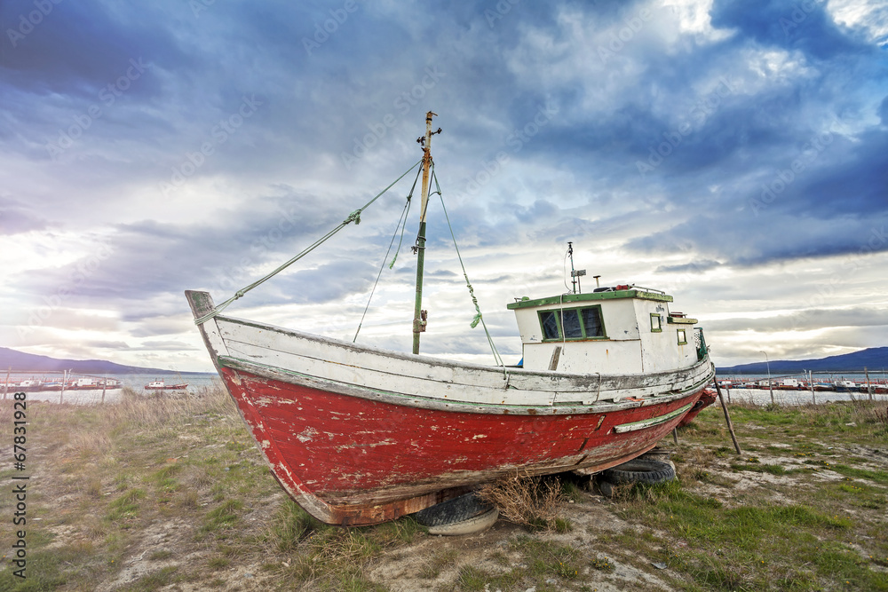 Old boat on a beach at sunset, Patagonia, Chile