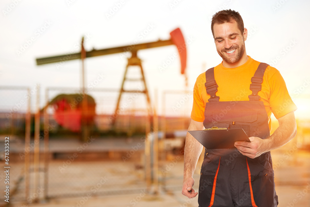 Refinery worker reads the data from the black plates Refinery worker reads the data from the black plates
