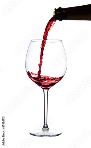 Pouring red wine. Isolated on white.