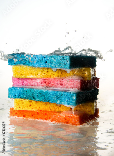 Mulit Colored Sponges Stacked on top of one another with Splash photo
