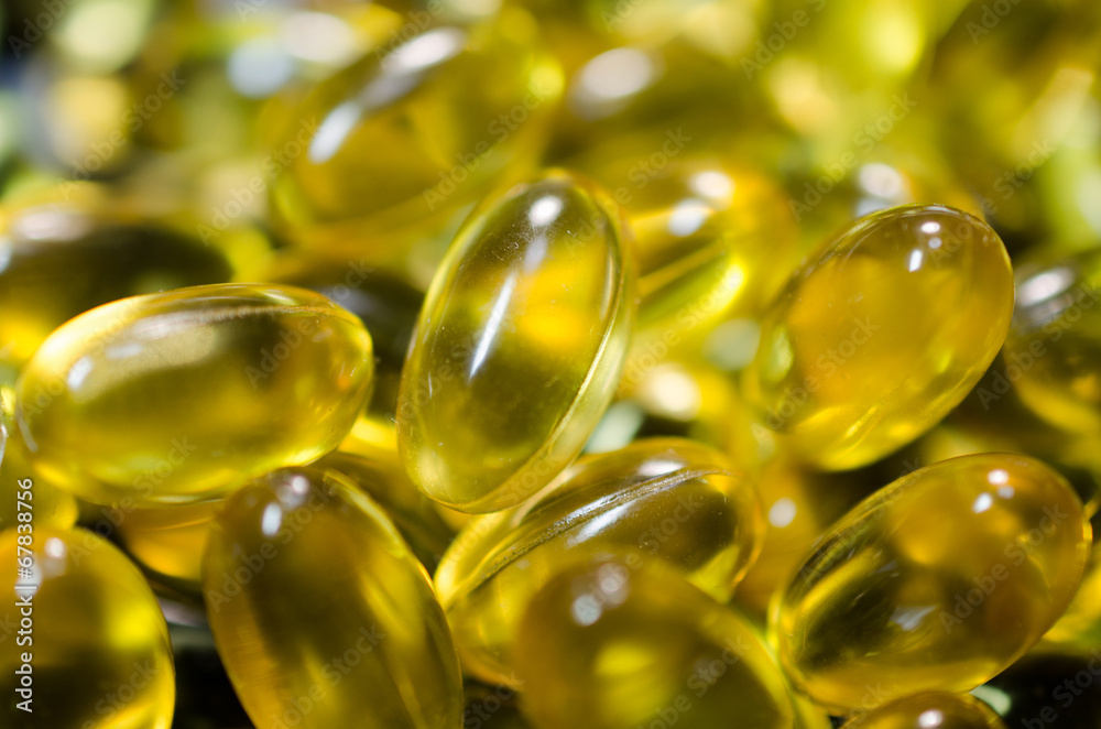fish oil pills closeup on black plate macro fish oil pills closeup on black plate macro