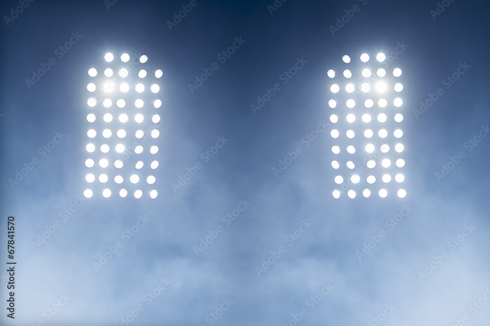 Fototapeta premium Stadium lights against dark night sky backgroundon