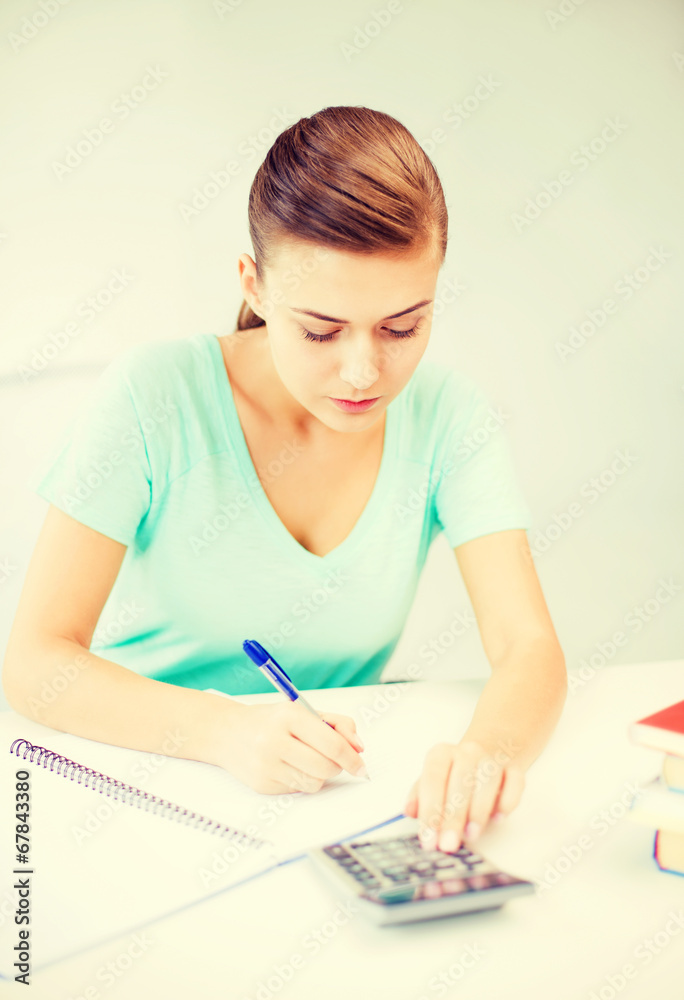 student girl with notebook and calculator