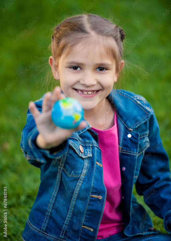 portrait of smiling girl holding globe in hand portrait of smiling girl holding globe in hand