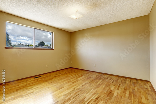 Empty room with window and hardwood floor