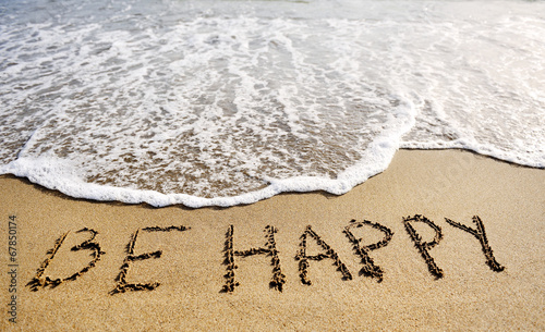 be happy words written on beach sand-positive thinking concept