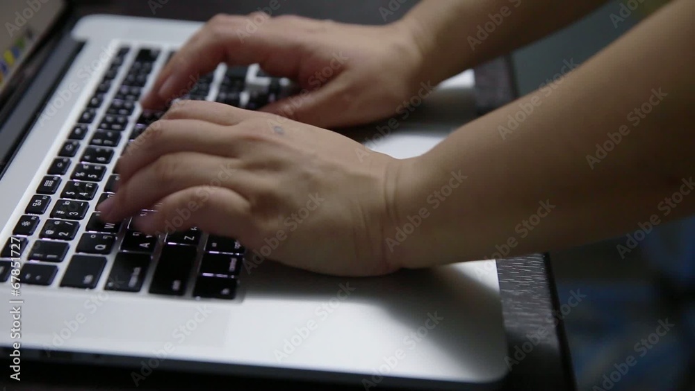 hand typing laptop in the dark hand typing laptop in the dark
