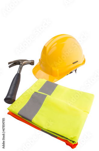 Yellow hard hat, a hammer and orange and yellow reflective vest  photo