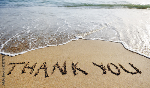 thank you word drawn on the beach sand photo