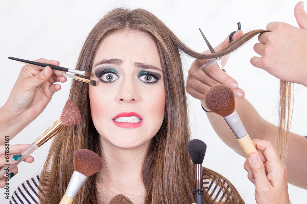 closeup of beautiful blond girl getting hair and makeup done Stock