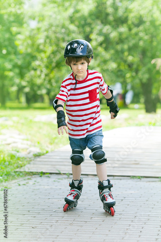 boy on rollers in the summer Park