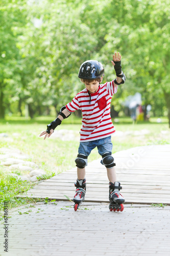 boy trains rollerblading in the Park