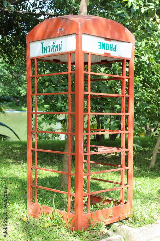 Old red telephone box in the park. Old red telephone box in the park.