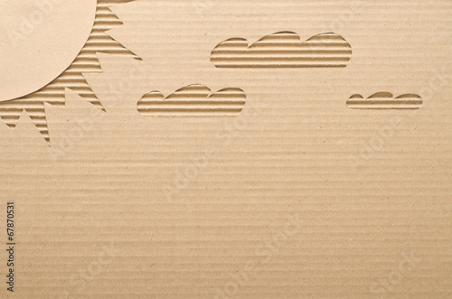 Sun and clouds cut out on cardboard