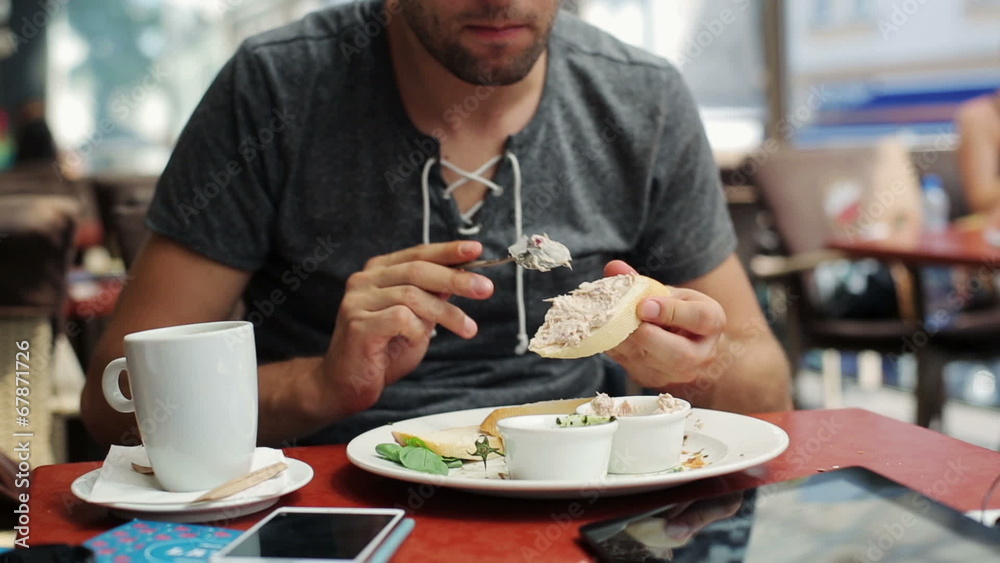 Man preparing, adding pasta on slice of bread in restaurant Man preparing, adding pasta on slice of bread in restaurant