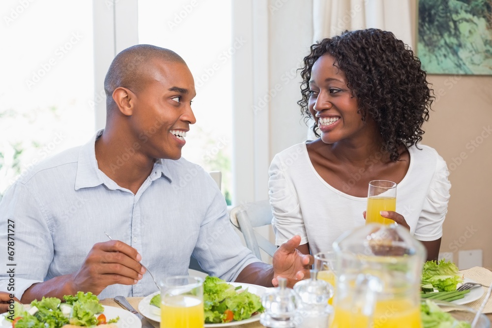 © WavebreakMediaMicro - Couple enjoying a healthy meal together smiling at each other