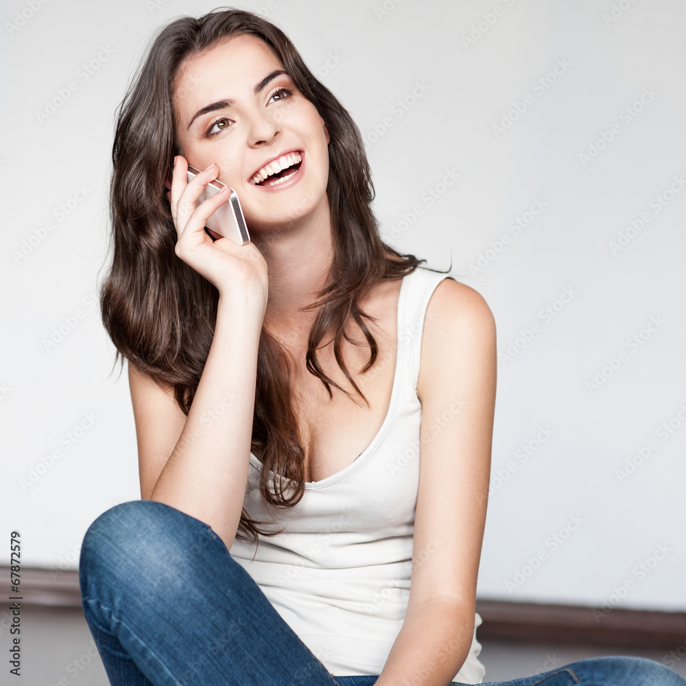 casual brunette girl holding cell phone