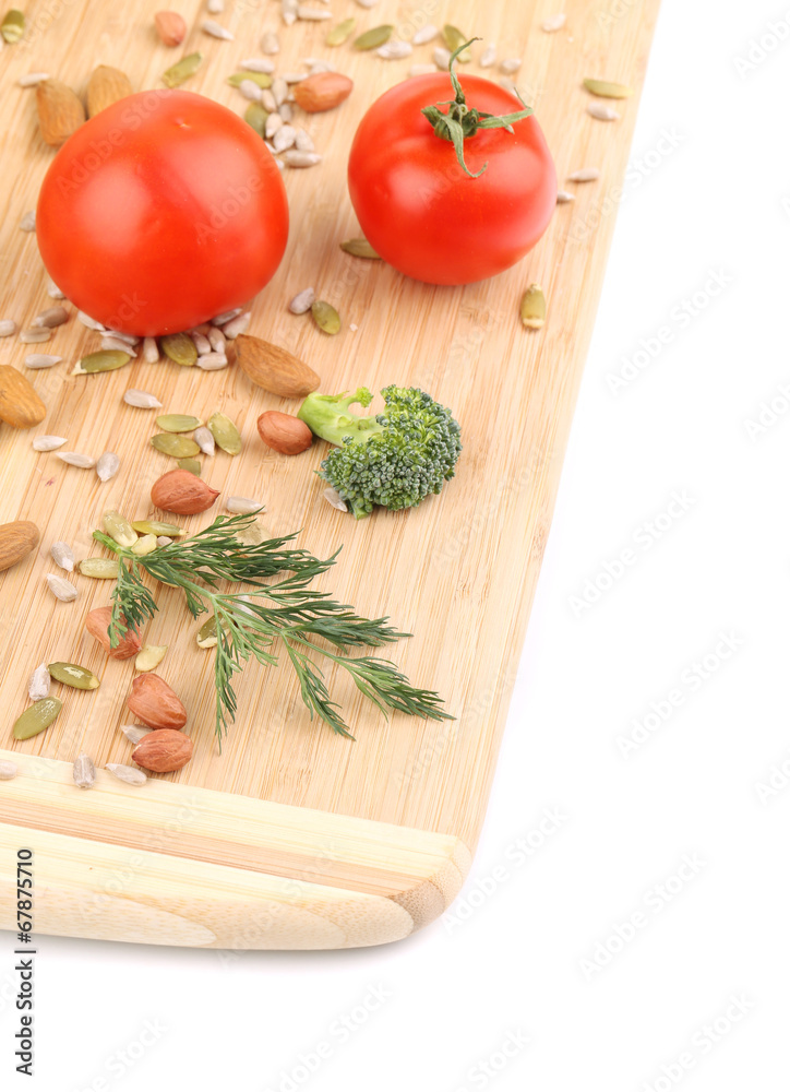 Vegetables with nuts on wooden platter.