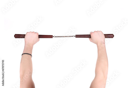 Hands hold martial arts nunchaku. photo