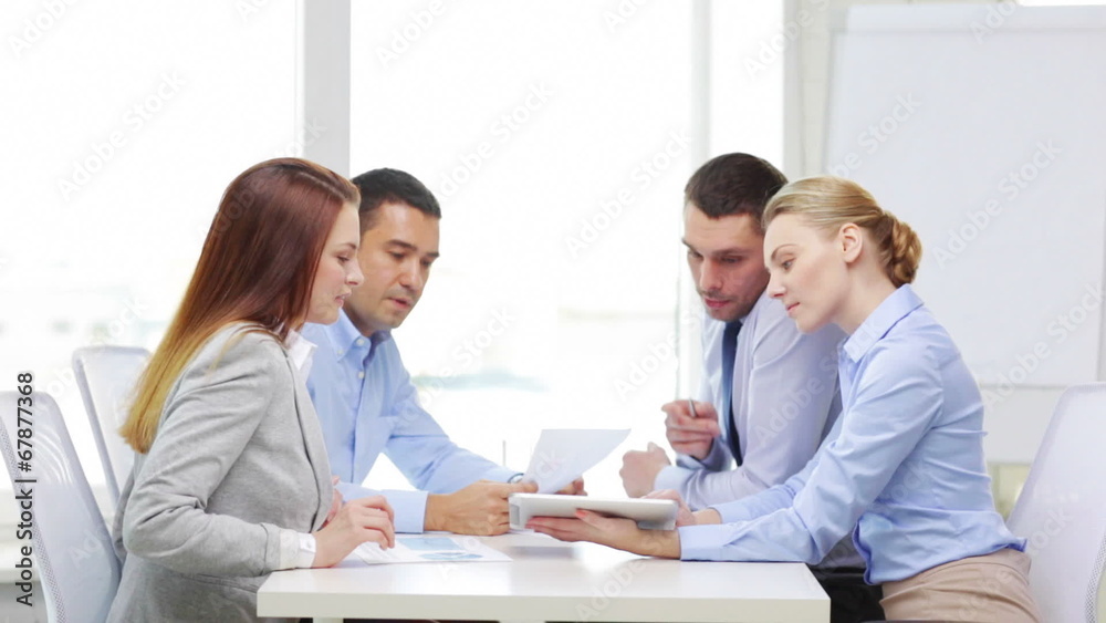 smiling team with table pc and papers working smiling team with table pc and papers working