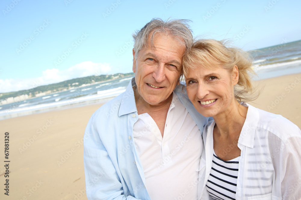 Cheerful senior couple standing on the beach