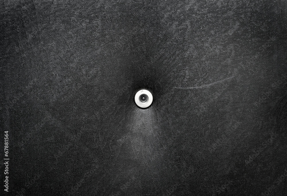 Peephole on a leather door Peephole on a leather door