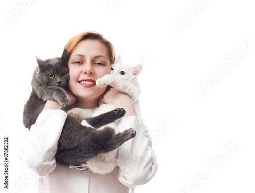 woman veterinarian holding two cats