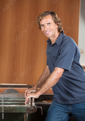 Portrait Of Confident Carpenter Using Tablesaw