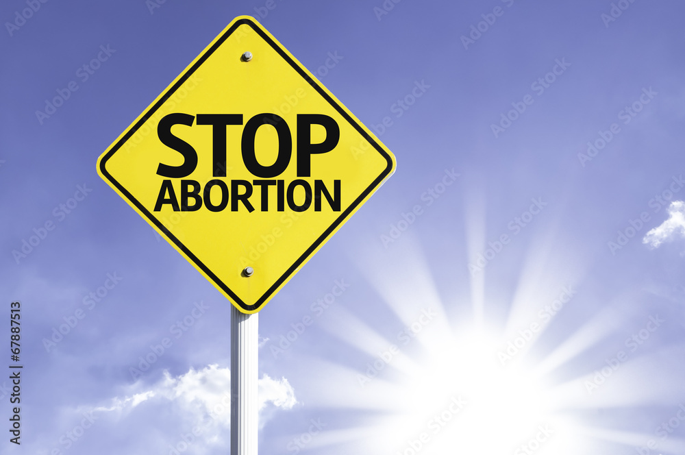 Stop Abortion road sign with sun background Stop Abortion road sign with sun background