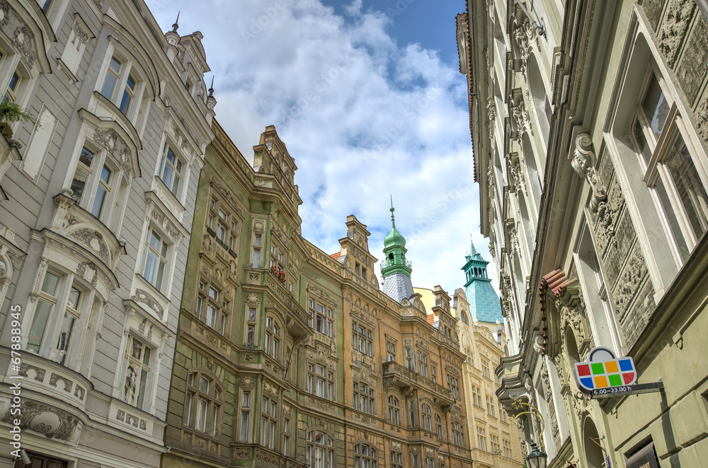 Obraz premium Facades of houses in narrow street in Prague Downtown