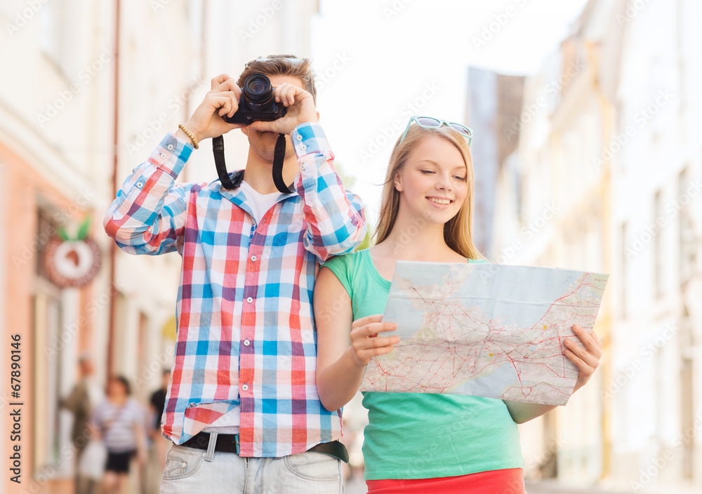 smiling couple with map and photo camera in city smiling couple with map and photo camera in city