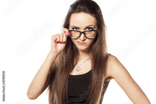 Fotografia suspicious angry young woman on white background