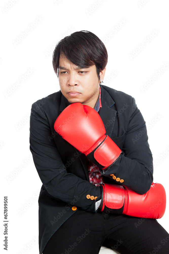 Asian man wear boxing gloves thinking of something Asian man wear boxing gloves thinking of something