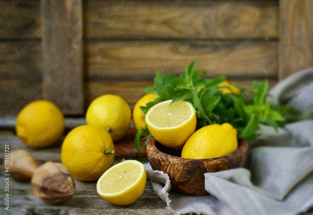 juicy and ripe organic lemons in on a wooden background
