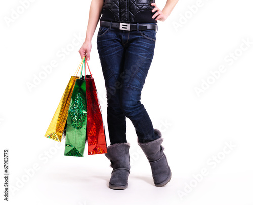 Woman in autumn boots with shopping bags.