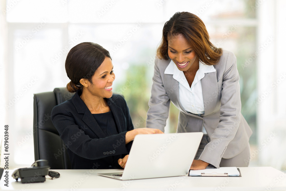 african business women working on a computer african business women working on a computer