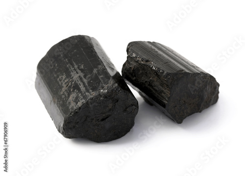 Black tourmaline raw rocks on the white background. photo