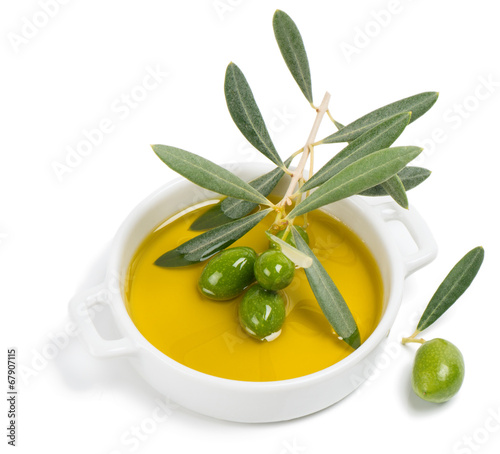 small bowl with olive oil, decorated with a small twig with gree